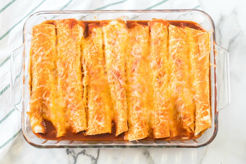 Easy Beef Enchiladas - Cooked enchiladas in baking dish - Family Fresh Meals