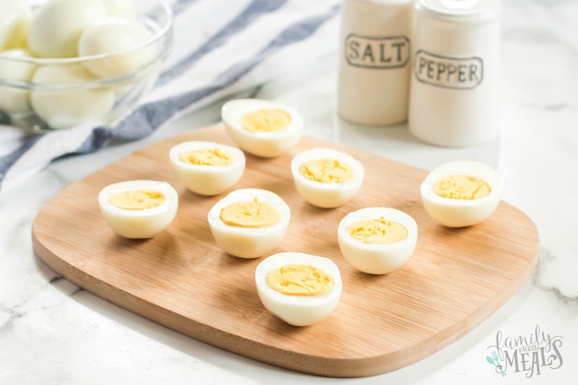 Instant Pot Hard Boiled Eggs - Perfect hard boiled eggs sliced on cutting board - Family Fresh Meals