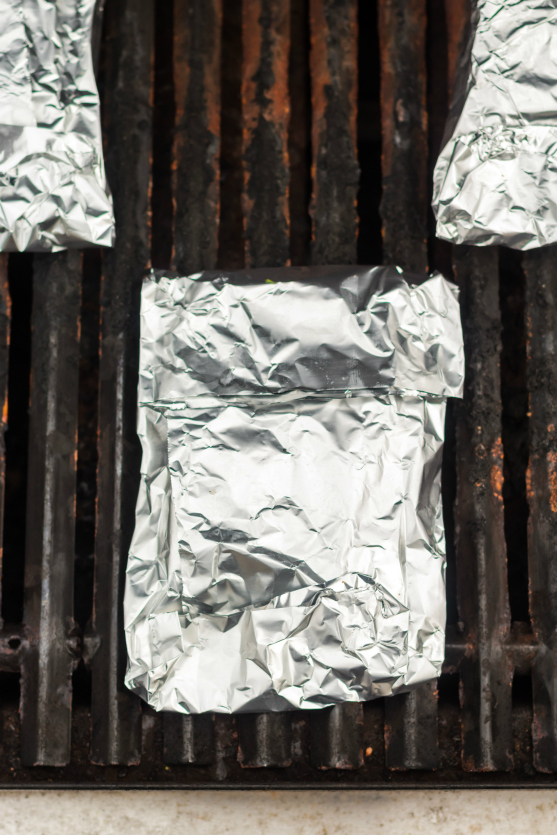 Asparagus Salmon Foil Packets - foil packets sealed and cooking on grill