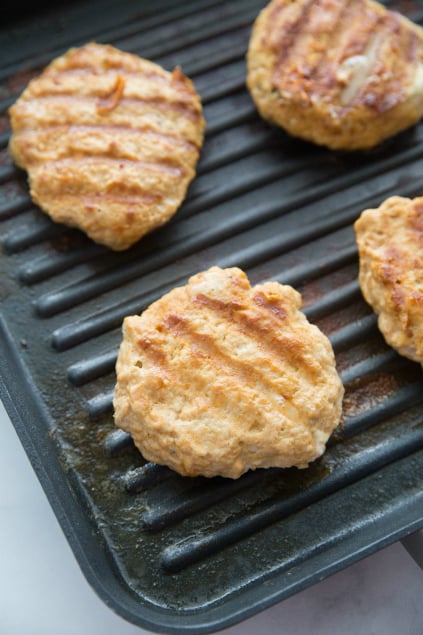 Buffalo Chicken Burgers - Chicken burgers grilling on grill pan