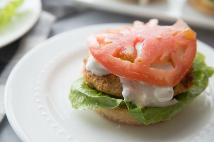 Buffalo Chicken Burgers - Fresh sliced tomato on top of burger