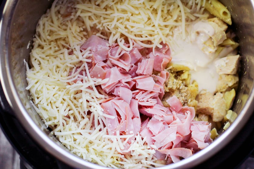 Instant Pot Chicken Corden Bleu Pasta - Ham, shredded cheese, sauce and seasonings adding into instant pot
