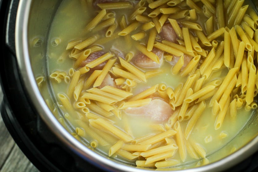 Instant Pot Chicken Corden Bleu Pasta - broth and water with noodles and chicken in instant pot