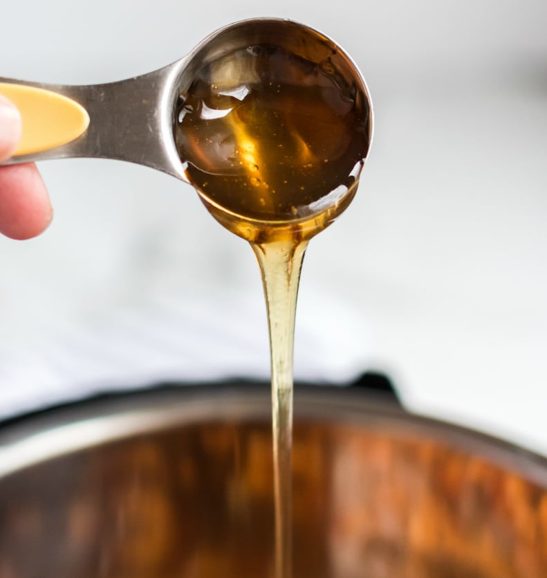 Instant Pot Orange Chicken - Pouring honey into instant pot