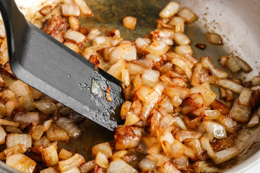 Copycat In N Out Animal Fries - sauting onions in a pan