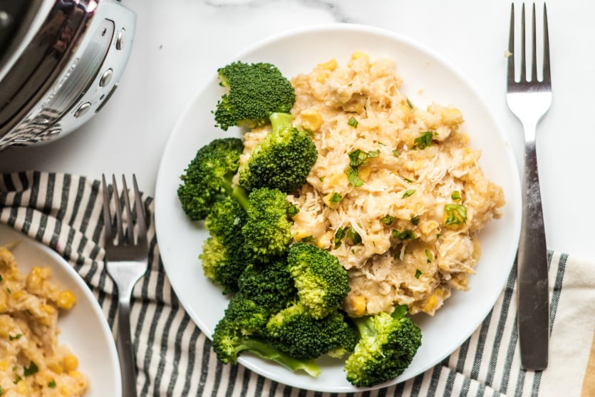 Crockpot Creamy Chicken and Rice - Served on a white plate with broccoli