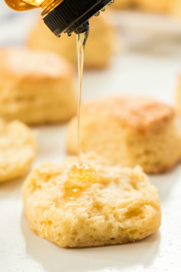 Easy Homemade Biscuits - Honey being drizzled on top of a biscuit