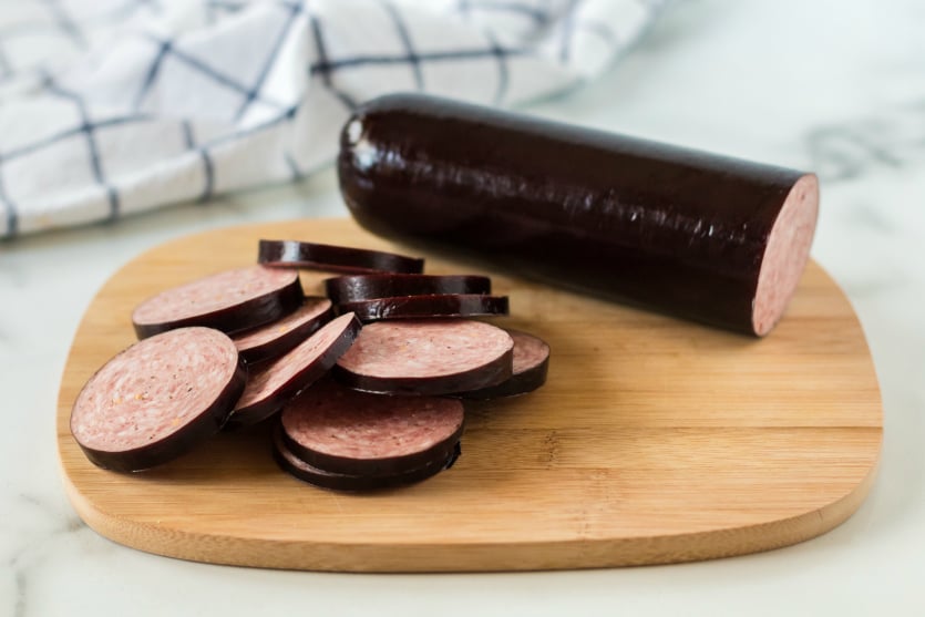 Pasta Salad Packed for lunch - Summer Sausage sliced on a cutting board