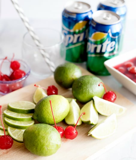 Sonic Cherry Limeade ingredients on cutting board - sprite, limes, cherries