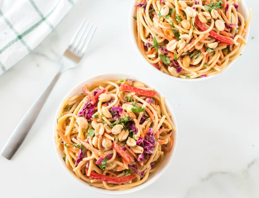 Thai Spaghetti Pasta Salad Recipe served in two white bowls and topped with peanuts- Family Fresh Meals