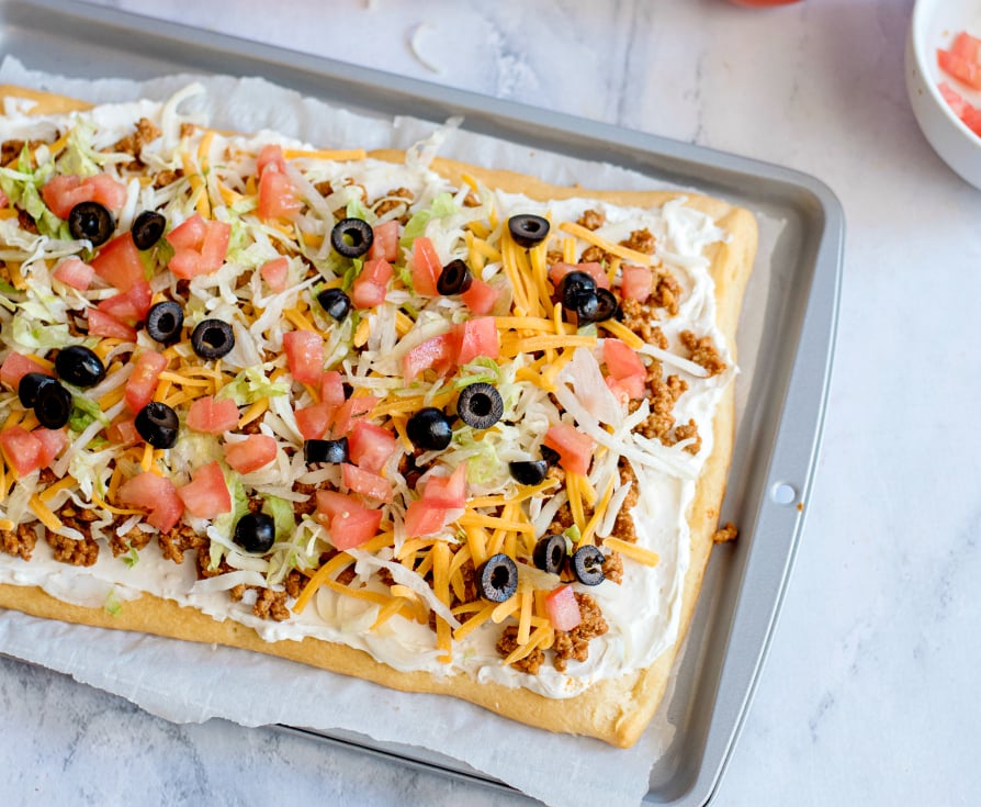 Easy Fiesta Taco Pizza -- Pizza topped with beef, shredded cheese, lettuce, olives and tomatoes
