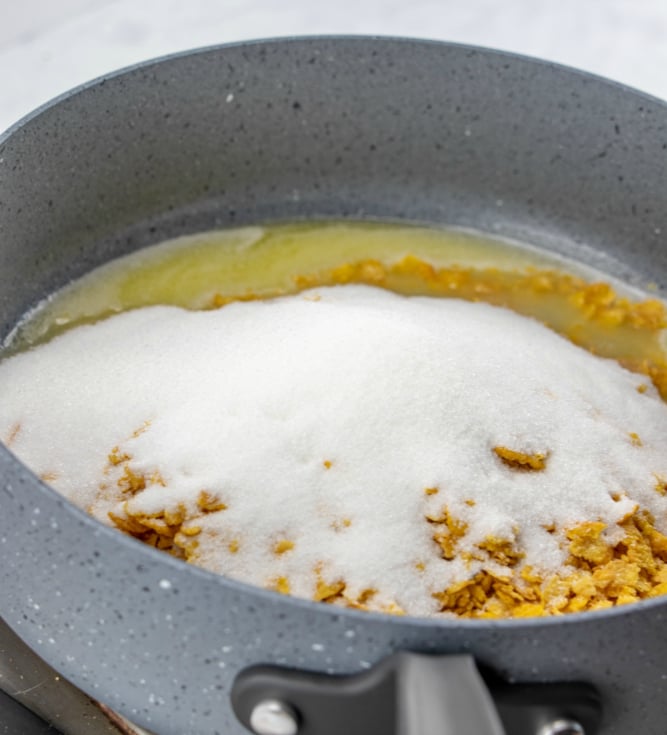 Fried Ice Cream Cake adding in sugar and corn flakes to melted butter in pan