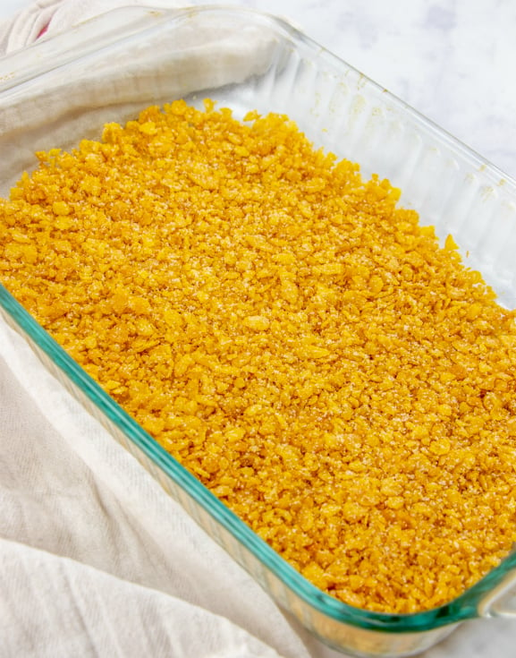 Fried Ice Cream Cake - corn flakes mixture layered in the bottom of a baking dish.