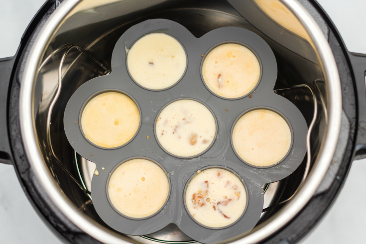 Instant Pot Bacon Cheddar Egg Bites - egg batter in egg bite molds in instant pot