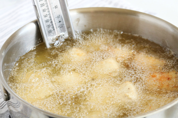 Copycat Chick Fil A Nuggets - chicken nuggets frying in pot