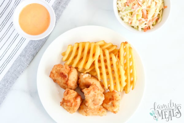 Copycat Chick Fil A Nuggets - nuggets served on a plate with waffle fries