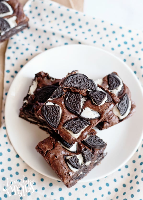 Oreo Stuffed Brownies - Oreo brownies stacked on a white plate.