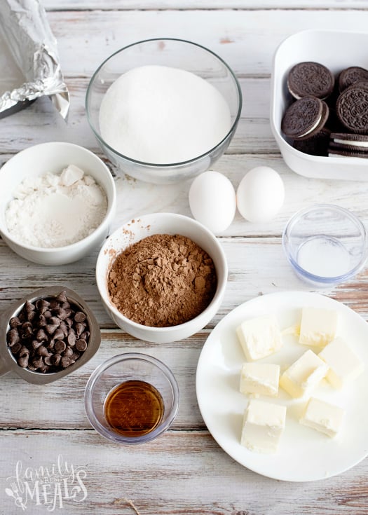 Oreo Stuffed Brownies - ingredients in bowls butter, sugar, flower, coco, chocolate chips, vanilla, salt, and oreo cookies