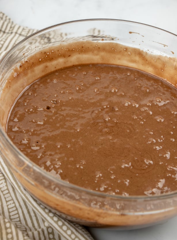 Chocolate Turtle Poke Cake - cake batter mixed in glass mixing bowl