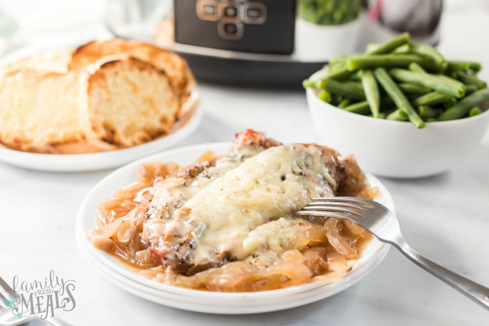 Crockpot French Onion Chicken - French onion chicken served on a white plate with green beans