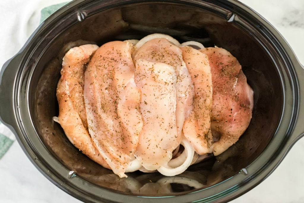 Crockpot French Onion Chicken - chicken and seasoning added to the slow cooker