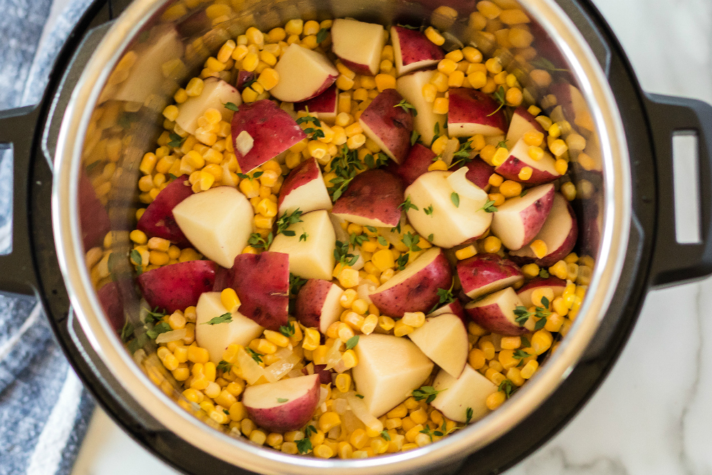 Instant Pot Potato Corn Chowder - corn, potatoes and seasoning added into instant pot