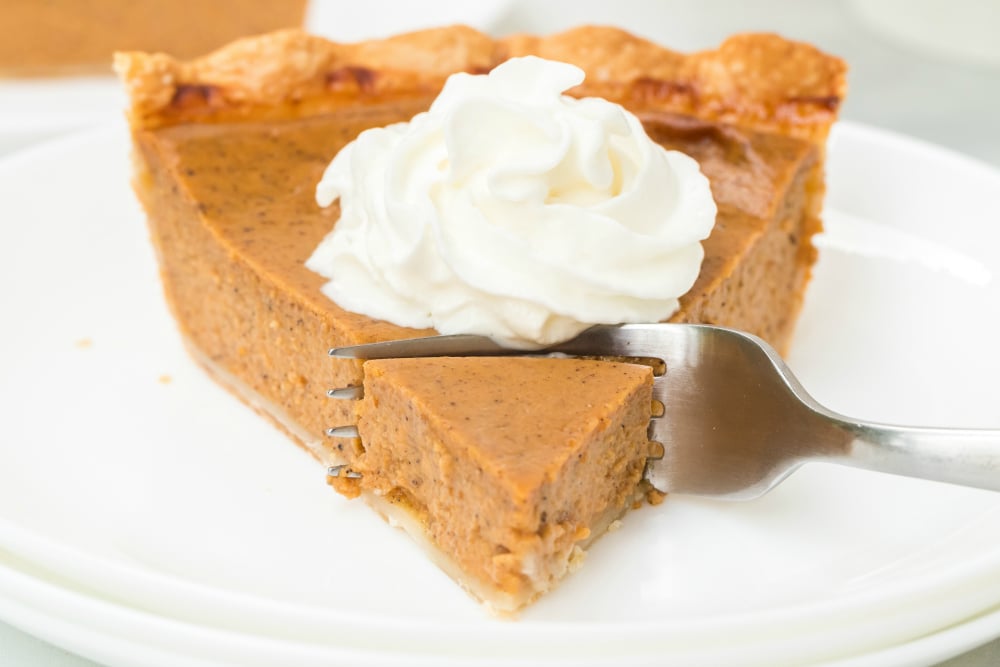 Easy Homemade Pumpkin Pie Recipe - fork taking a piece of pie