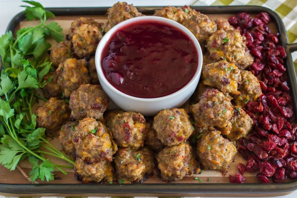 Sausage Stuffing Bites with Cranberry Dipping Sauce - served on a serving platter with cranberry dipping sauce