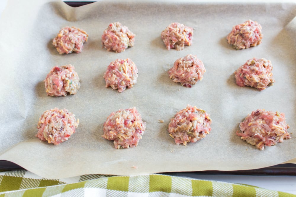 Sausage Stuffing Bites with Cranberry Dipping Sauce - stuffing balls laid out on a prepared baking sheet