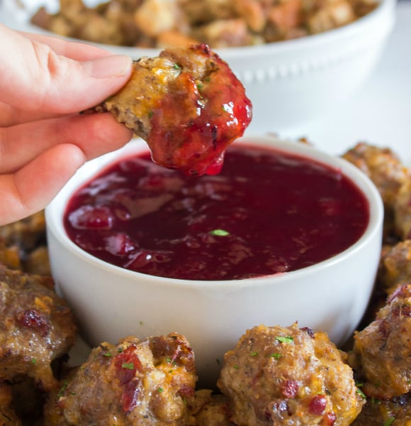 Sausage Stuffing Bites Recipe - Dipping in cranberry dipping sauce