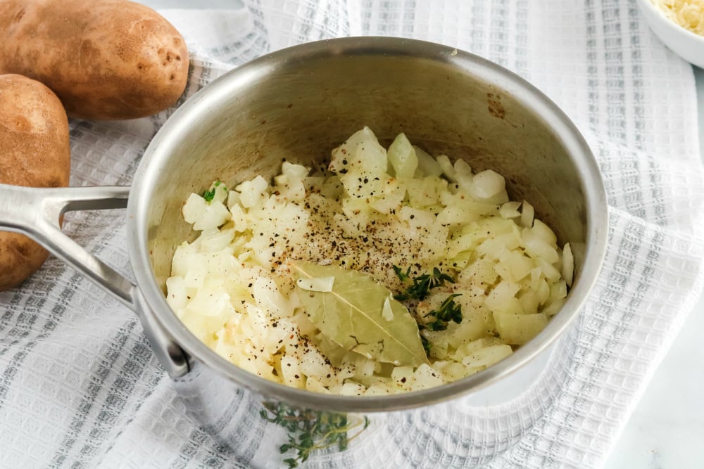 Creamy Potatoes Au Gratin - onions, seasoning and herbs in cooking pot