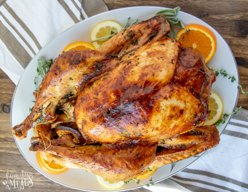 Roasted Thanksgiving Turkey Recipe - roasted turkey served on a large plate