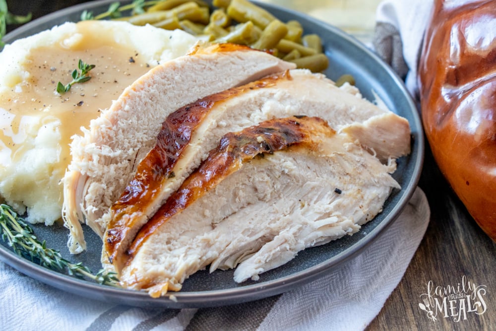 Roasted Thanksgiving Turkey sliced and served on a blue plate