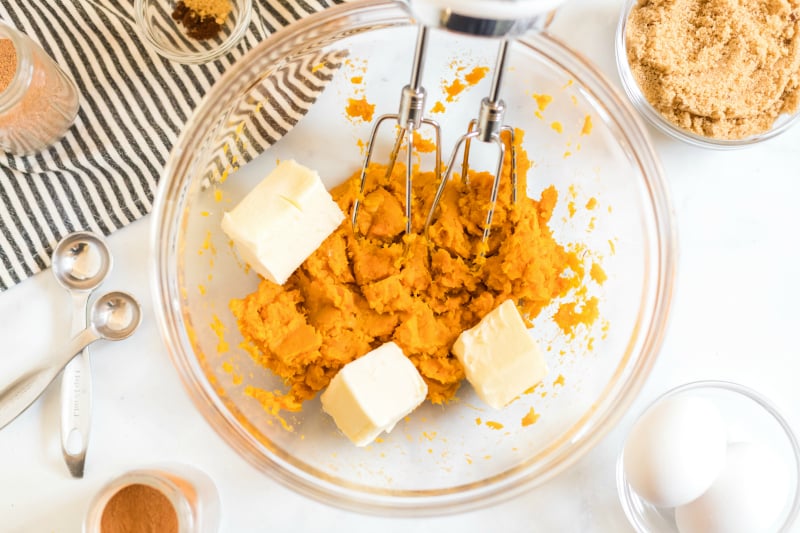 Sweet Potato Pie - sweet potato mixture and butter in mixing bowl