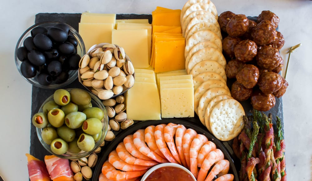 New Years Appetizer Meat and Cheese Board - Cheese, crackers, meatballs, olives and nuts