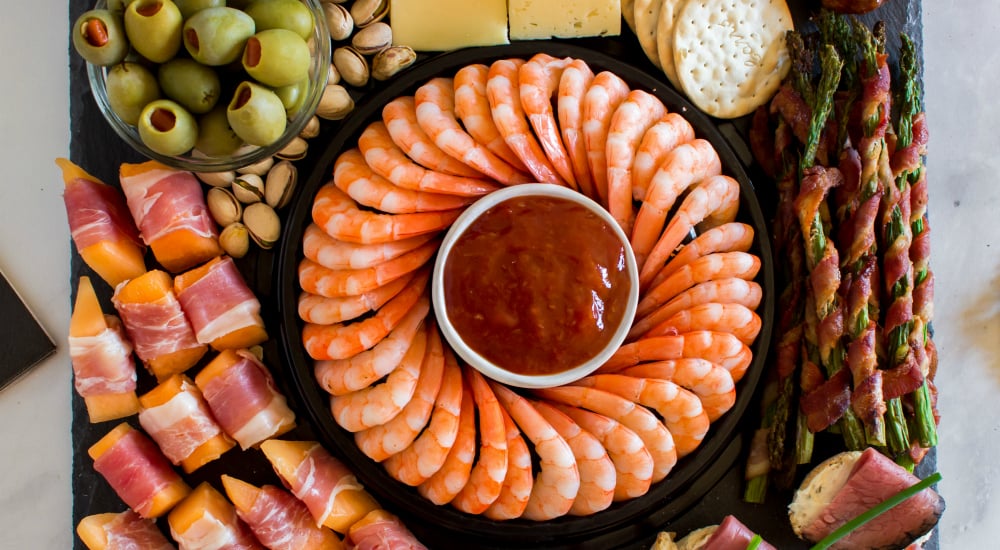 New Years Appetizer Meat and Cheese Board - bacon wrapped asparagus and shrimp cocktail