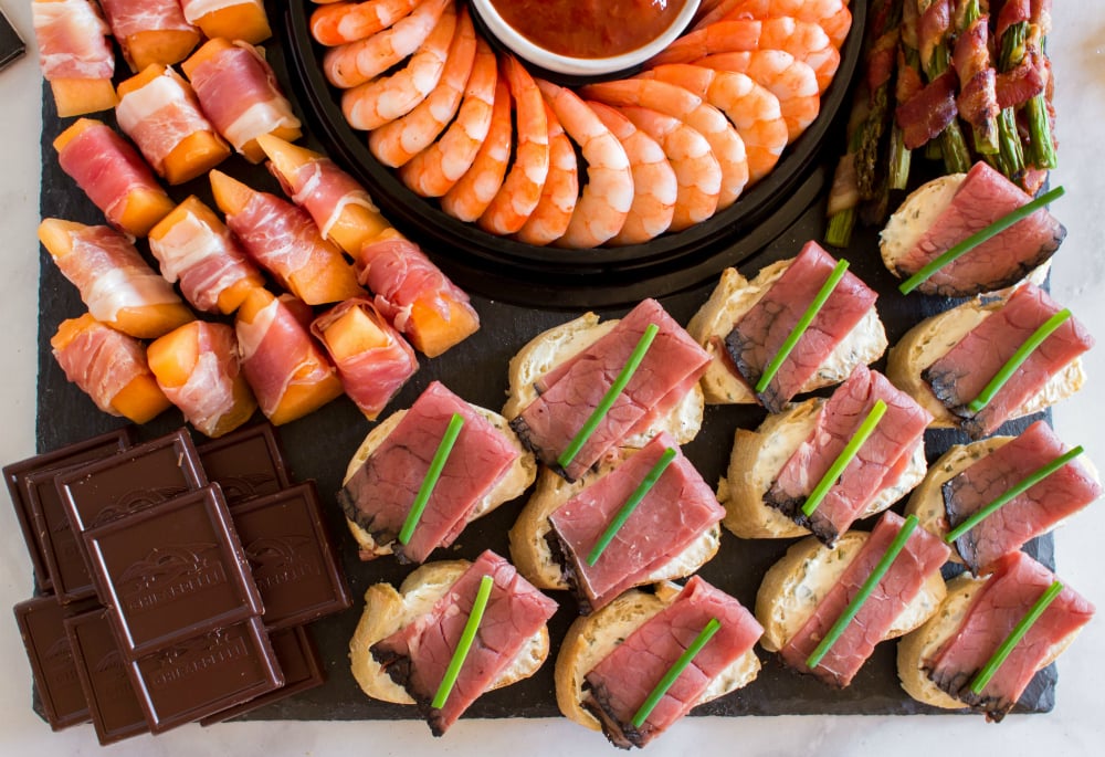 New Years Appetizer Meat and Cheese Board - proccuito wrapped melon, chocolate and beef canapé