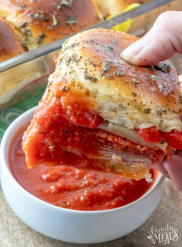 Hot Italian Sub Sliders - slider being dipped in marinara sauce