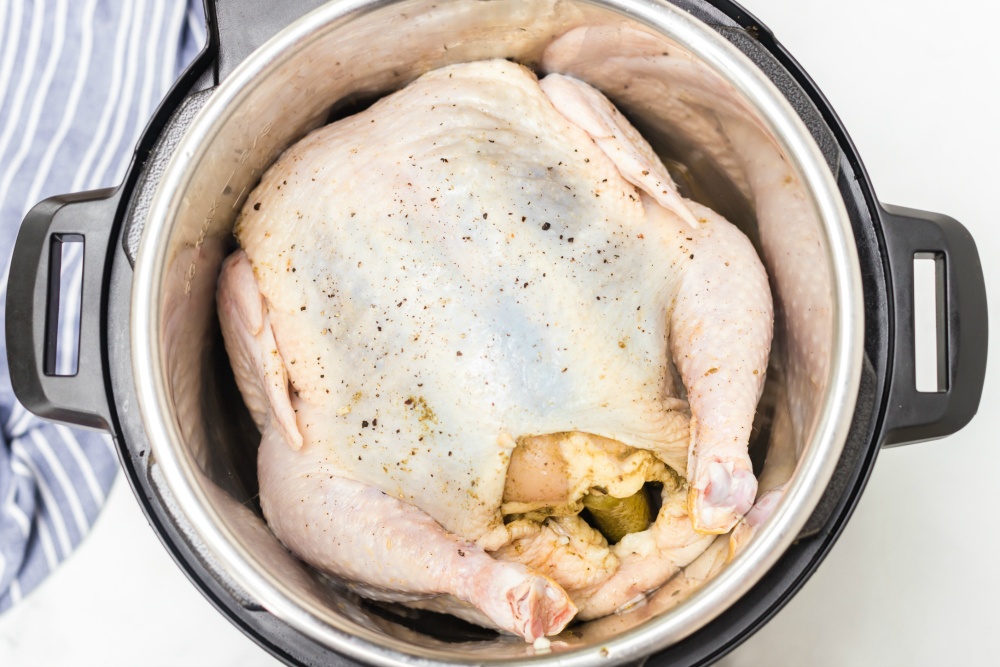 Instant Pot Dill Pickle Chicken - whole chicken stuffed with pickles inside pressure cooker