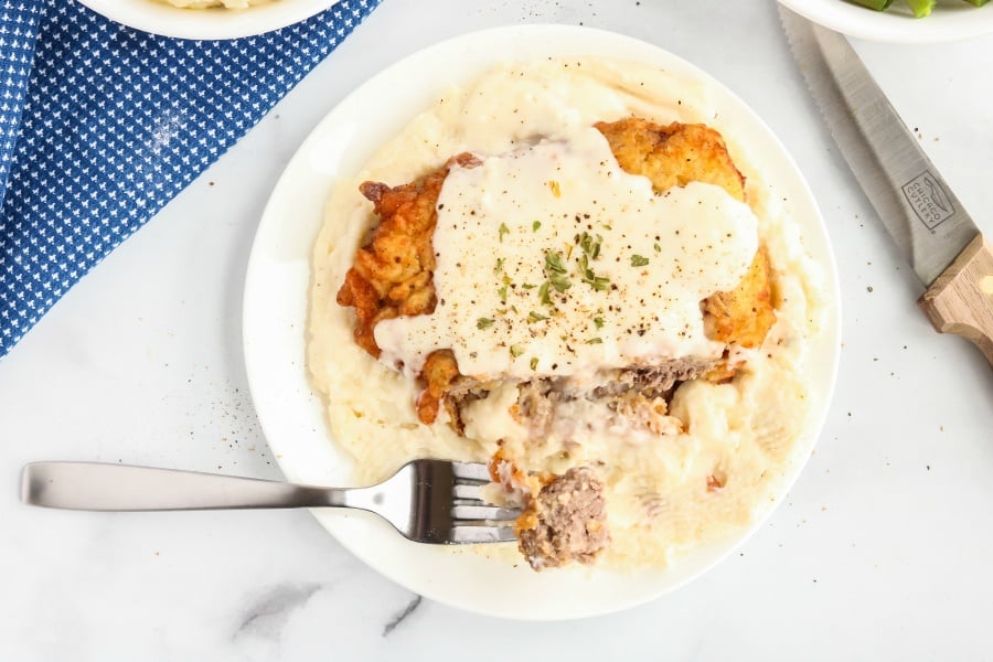 Chicken Fried Steak with White Gravy Recipe served over potatoes