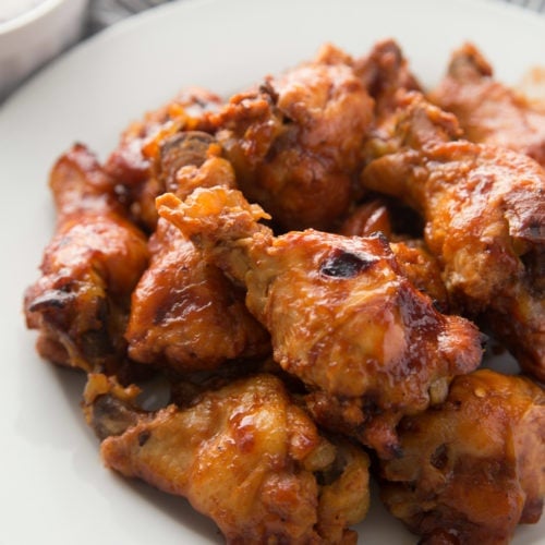 Chicken wings served on a white plate