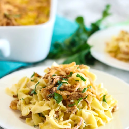 Casserole served on a white plate, and topped with fresh parsley