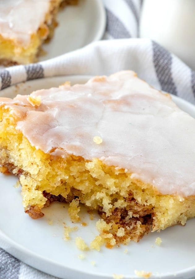 Sliced of cake on a white plate, part fo the cake has been eaten