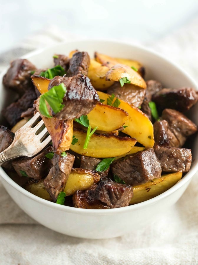 One Pot Steak and Potato Bites in a white bowl