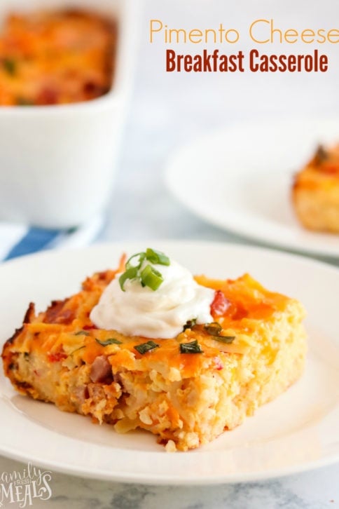 Pimento Cheese Breakfast Casserole - a piece of breakfast casserole on a white plate, topped with a dolip of sour cream and sliced green onions - words on the upper right saying pimento cheese breakfast casserole.jpg