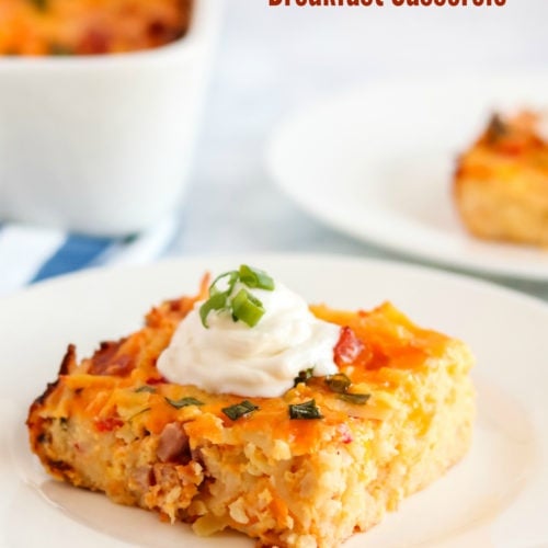 Pimento Cheese Breakfast Casserole - a piece of breakfast casserole on a white plate, topped with a dolip of sour cream and sliced green onions - words on the upper right saying pimento cheese breakfast casserole.jpg