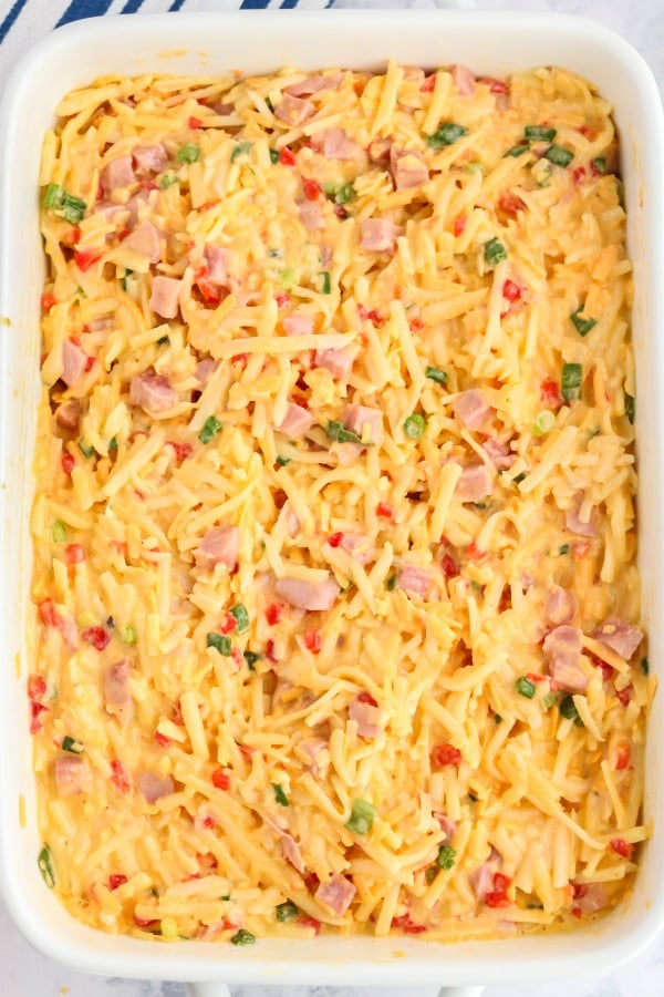 Top down picture of the unbaked pimento cheese breakfast casserole in a 9 X 13 baking dish