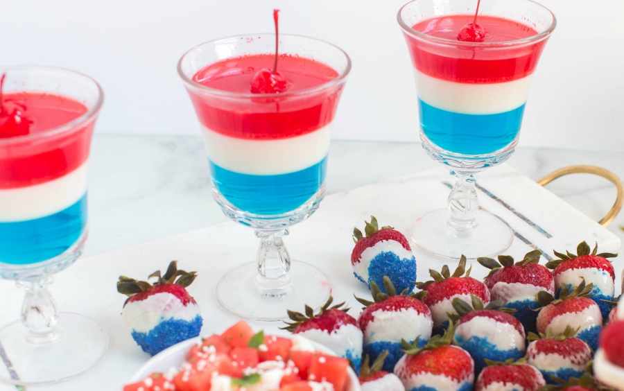  3 red white and blue jello desserts in glass cups