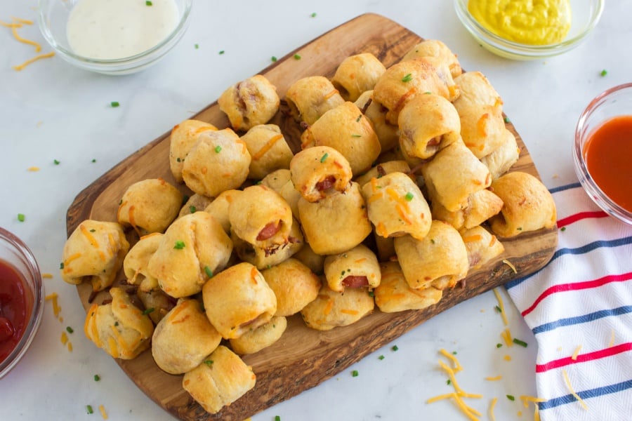 top down image of hotdog nuggets on a wooden serving platter