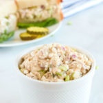 Cottage Cheese Tuna Salad in a small white bowl, with a sandwich in the background